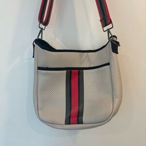 HAUTE SHORE Cream Crossbody Bag with Red and Black Accents